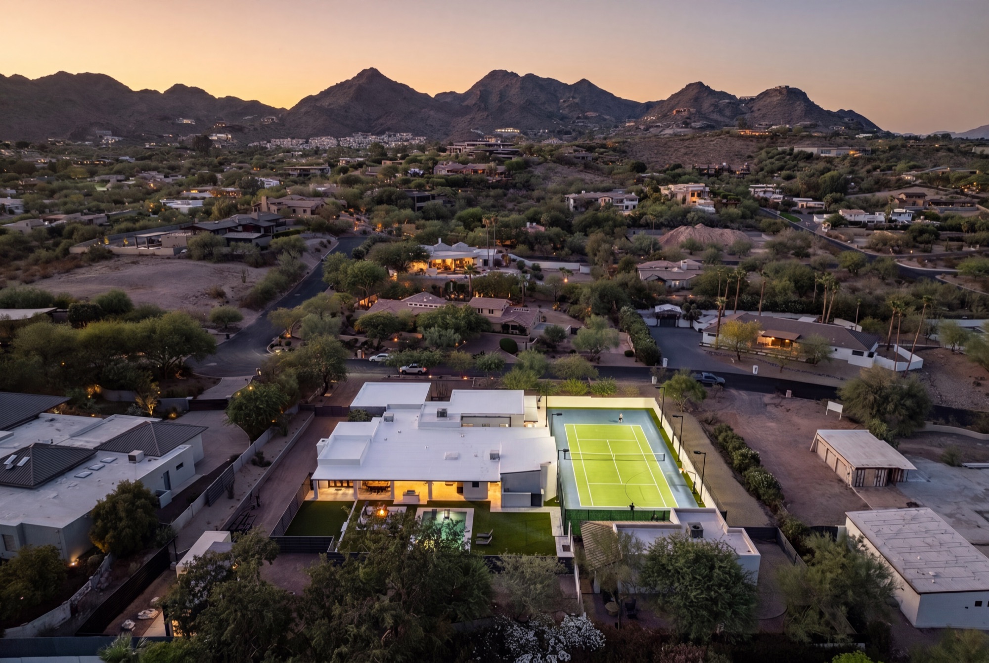 Dusk aerial of the estate beneath Camelback Mountain