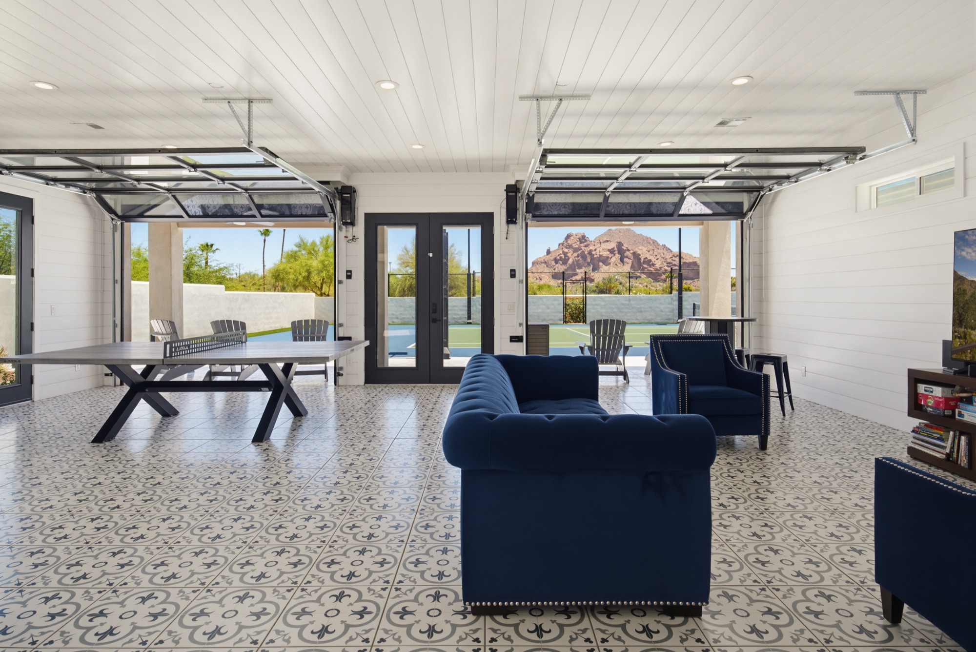 Games pavilion with glass garage doors framing Camelback